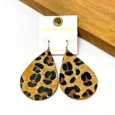 Large leopard print drop earrings.Pictured on a white background with a wood piece in the top right corner. Trendy Leopard Print Dangle Earrings, Trendy Leopard Print Dangle Jewelry, Handmade Leopard Print Earrings, Trendy Leopard Print Earrings As Gift, Trendy Brown Hypoallergenic Earrings, Trendy Hypoallergenic Brown Earrings, Trendy Hypoallergenic Earrings, Giddy Up Glamour, Large Size