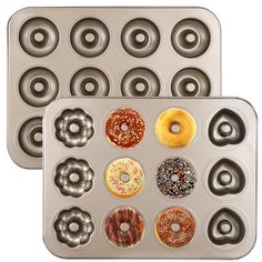 two metal trays filled with donuts on top of each other