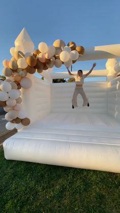 a man is jumping on an inflatable stage