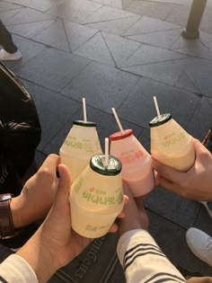 four people holding drinks in their hands