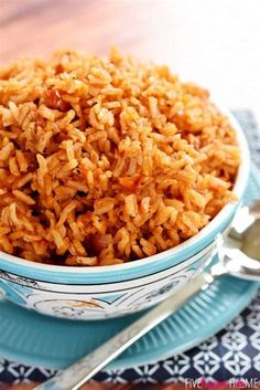 a bowl filled with rice sitting on top of a blue plate