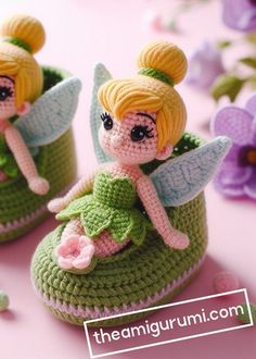 two crocheted little fairy dolls sitting on top of each other's shoes