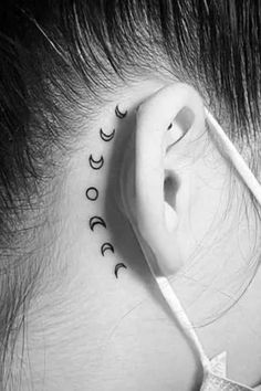 a woman with ear piercings that have the words moon and stars on their ears