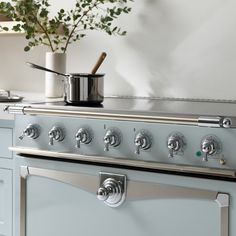 an old fashioned stove with pots and pans on it's burners in a kitchen