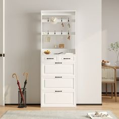 a white cabinet with umbrellas and other items on it in a living room area