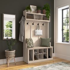 a white bench sitting next to a window in a room with green plants on it