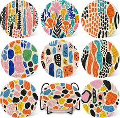 six plates with different designs on them, each painted in different colors and shapess