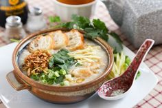 a bowl of soup with bread and vegetables