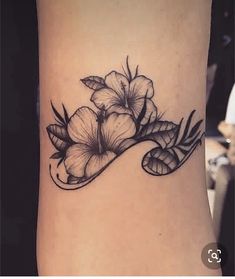 a black and white flower tattoo on the ankle