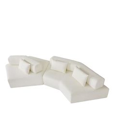 a white couch sitting on top of a white floor