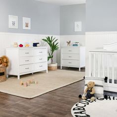 a baby's room with two cribs, a dresser and a teddy bear