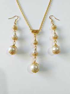 Gold pearl Victorian jewelry set Wedding gold set necklace earrings gold Boho jewelry set Bridal pearl jewelry set Gift pearl set earrings Beautiful Set of gold tone filigree ornaments and white crystal pearl's beads and glass pearl beads pendant necklace and earrings. Antique style filigree gold tone set necklace and earrings . Gold tone glass pearls Bohemian necklace and earrings . Boho necklace . Boho jewelry set . Boho pearl earrings . Bohemian necklace and earrings . Birthday set  necklace and earrings . Gold-tone Ibiza style jewelry set . Bridal jewelry set. Jewelry set for wedding. Birthday gift set. Wedding pearl jewelry set. Bridal jewelry set. This set is a beautiful Gift for Girlfriend, for sister, for mother,for bridesmaids or Maids of Honor, or for yourself.  Gift jewelry set. Wedding Filigree Jewelry Sets, Wedding Jewelry Sets With Filigree, Elegant Pearl Jewelry Sets With Matching Earrings, Formal Pearl Jewelry Sets With Elegant Design, Gold Pearl Bridal Earrings For Anniversary, Gold Pearl Jewelry With Round Shape, Gold-plated Beaded Jewelry For Wedding, Delicate Gold Jewelry With Pearl Drop, Elegant Gold Dangle Jewelry Sets