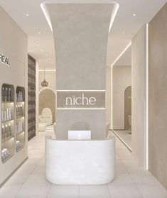 the interior of a nail salon with white walls and flooring, lighted by recessed lighting