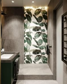 a bathroom with a glass shower door and green accents on the wall, along with two sinks