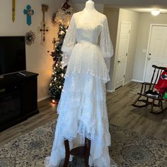 a white dress on display in front of a christmas tree