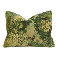 a green and yellow pillow with flowers on it