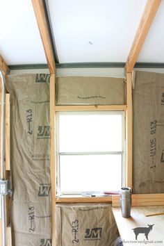 an unfinished room with wood framing on the walls