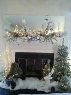 a fireplace decorated for christmas with white lights and evergreens on the mantel above it