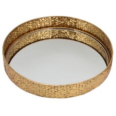 two round metal trays with gold speckles on the rim, one holding a mirror