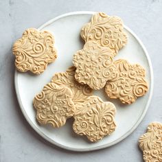 some cookies are sitting on a white plate