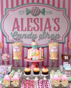 a candy shop display with pink and white striped walls, lots of candies on the table