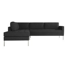 a black sectional couch sitting on top of a white floor