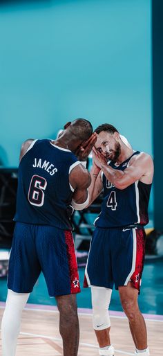 two basketball players standing next to each other on a court