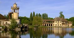 an old building sitting on top of a lake