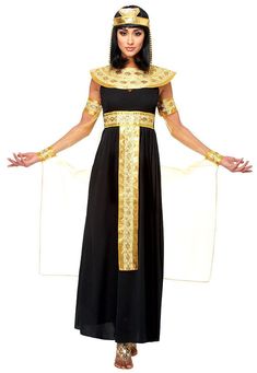 an egyptian woman in black and gold costume with her hands on her hips, posing for the camera