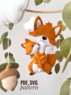 two stuffed animals hanging from a tree branch