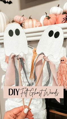 two paper ghost masks on sticks with text overlay that says diy craft ghost wands