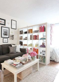 a living room filled with furniture and lots of books