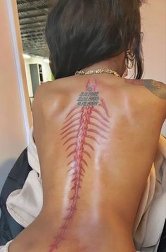 a woman with a tattoo on her back