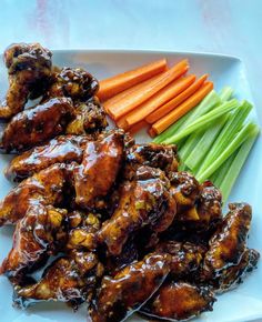 chicken wings, carrots and celery on a plate