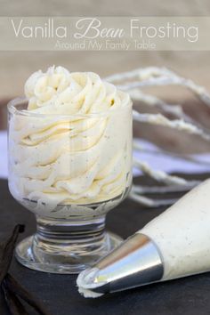 vanilla bean frosting in a small glass dish with a pastry roller on the side