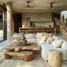 a living room filled with lots of furniture next to a wooden table and ceiling fan