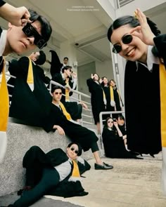 some people in suits and ties are posing for a photo on the steps with their sunglasses on