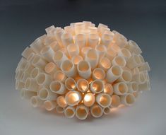 a light made out of plastic tubes sitting on top of a table