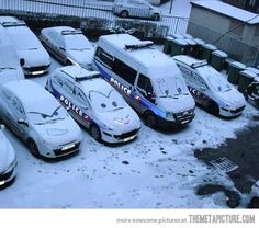 there are many police cars parked in the snow