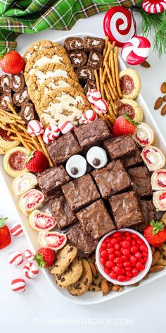 a platter filled with cookies, pretzels and candy canes for christmas