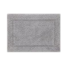 a gray bath mat on a white background