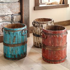 three buckets sitting next to each other on the floor