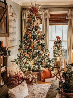 a living room with a christmas tree in the corner and other decorations on the wall