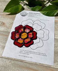 a flower is shown on top of a piece of paper