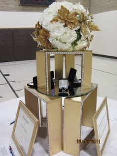 a glass table topped with flowers and pictures