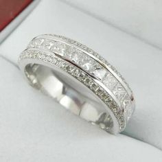 a white gold ring with princess cut diamonds