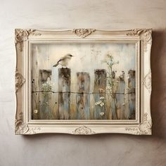 a painting hanging on the wall above a white framed frame with flowers and a bird flying over it