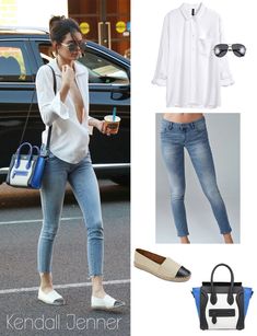 a woman in white shirt and jeans holding a cell phone next to a blue handbag