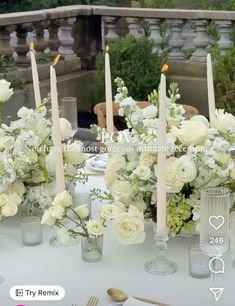 the table is set with white flowers and candles