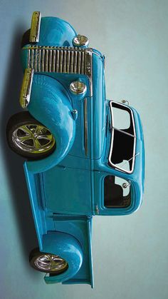 an old blue toy car is hanging on the wall